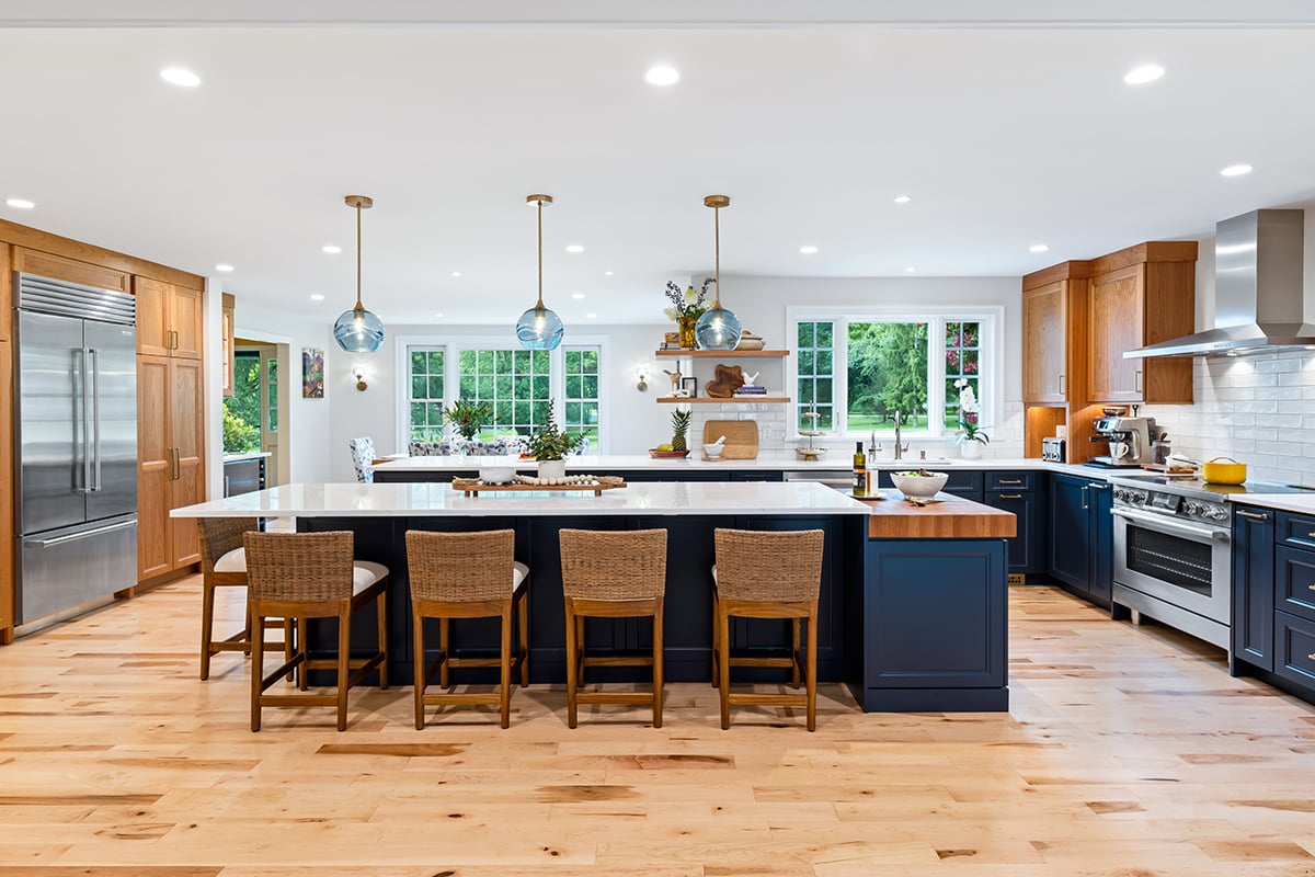 large kitchen island with storage and butcher block for cooking