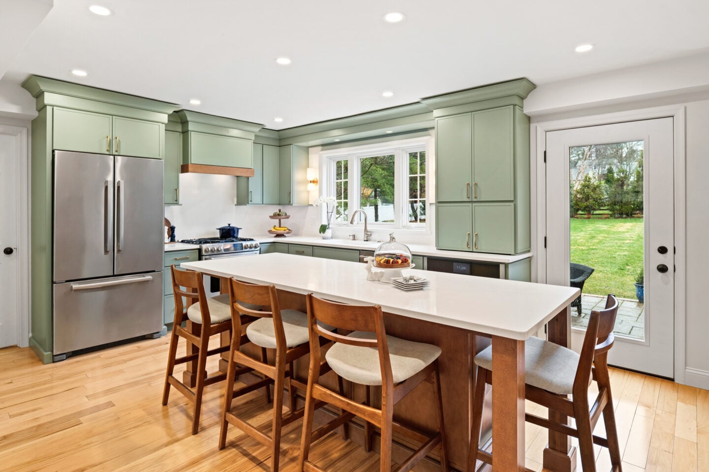 Kitchen island with seating, quartz countertop, and recessed lighting in a Collegeville home