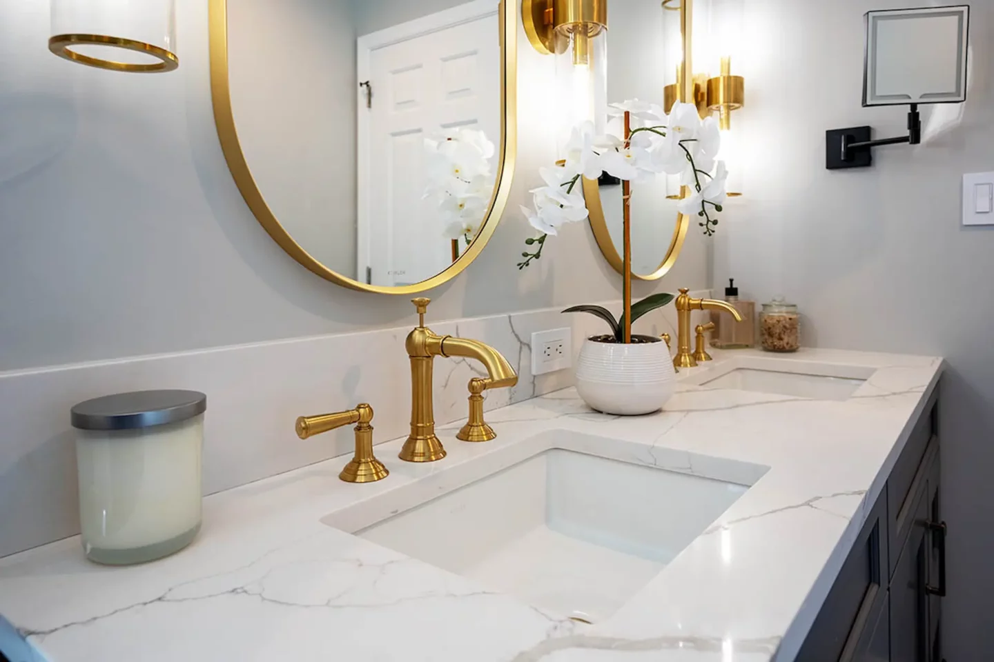 Gold colored tap, knobs and mirror frames above a vanity in Lower Gwynedd Primary Bathroom
