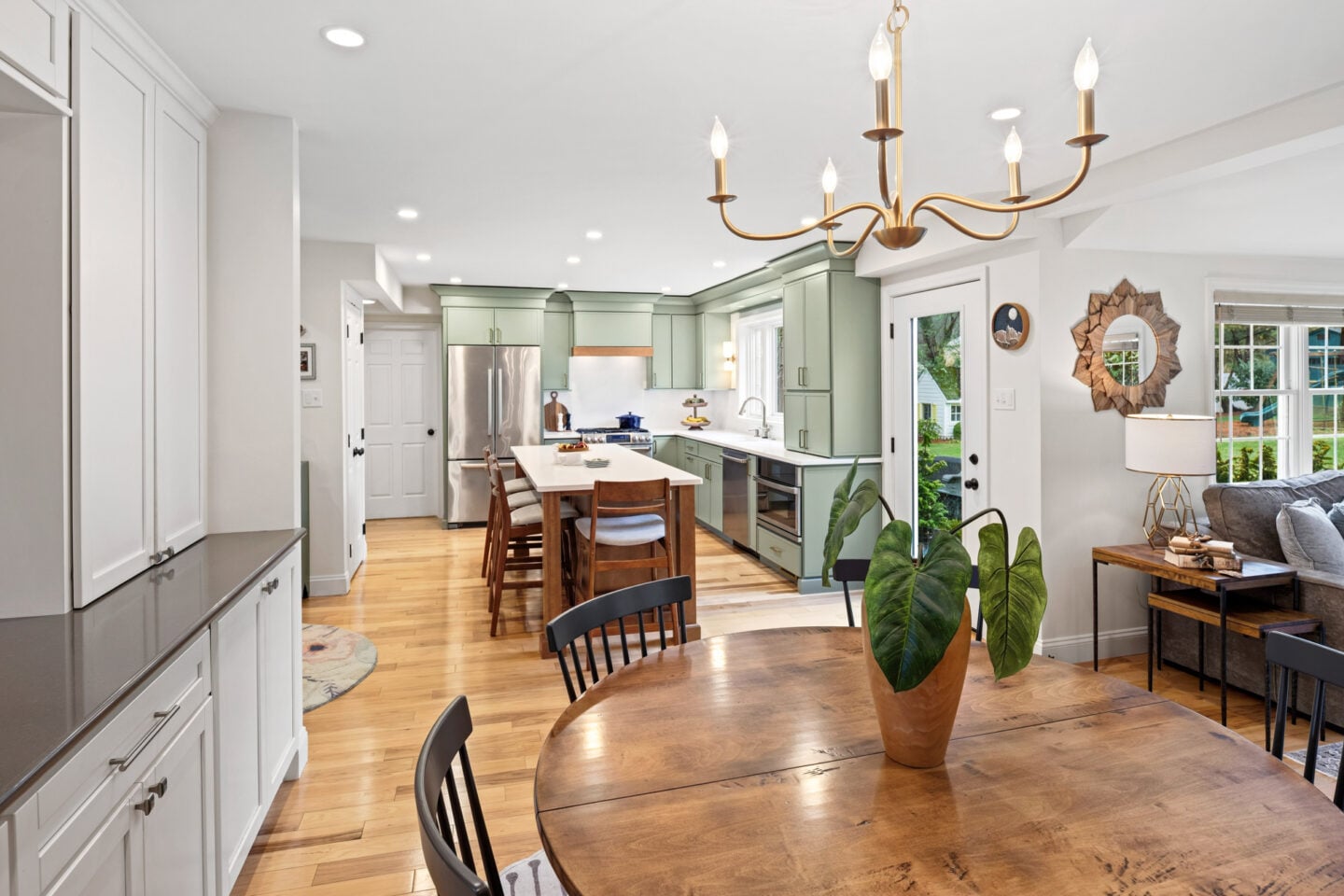 Open floor plan connecting kitchen, dining, and living areas in remodeled home