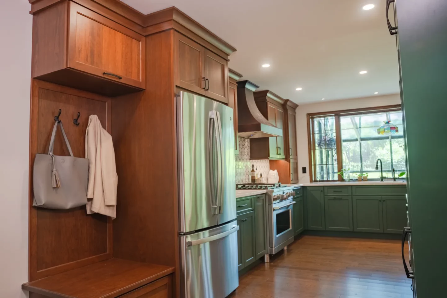 Custom mudroom storage featuring built-in cabinetry and convenient organization near the garage entry.