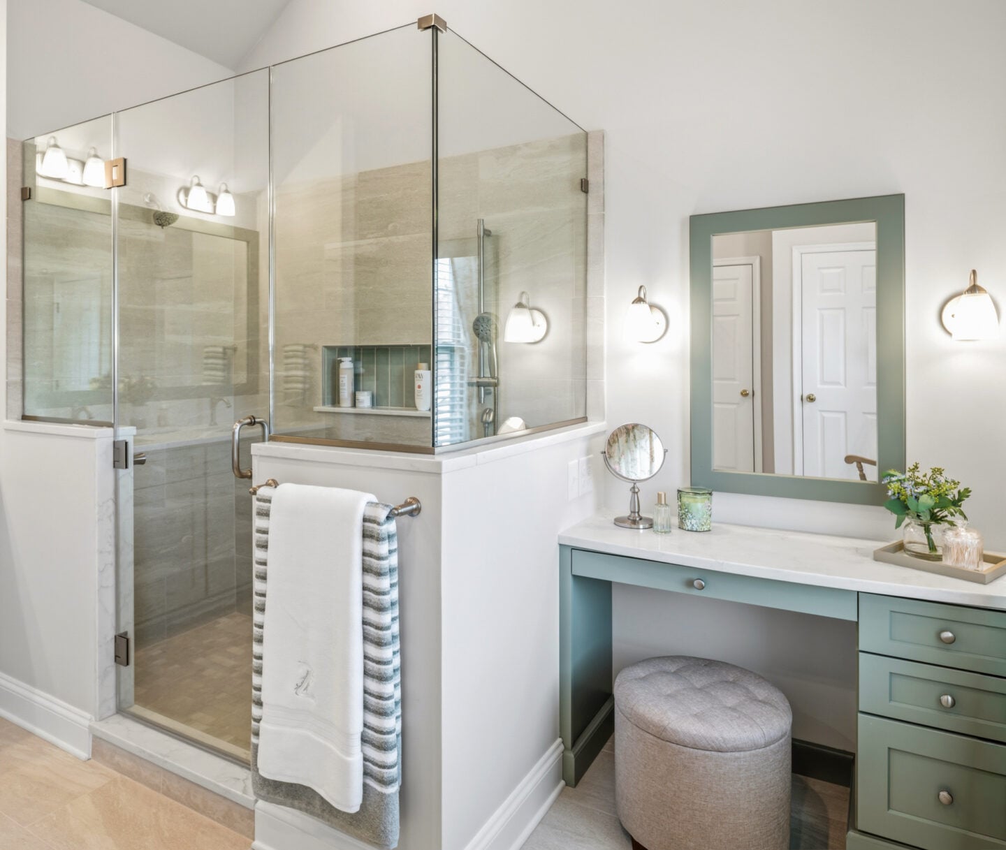 Frameless glass walk-in shower with built-in bench and tile surround in a Harleysville primary bathroom renovation.