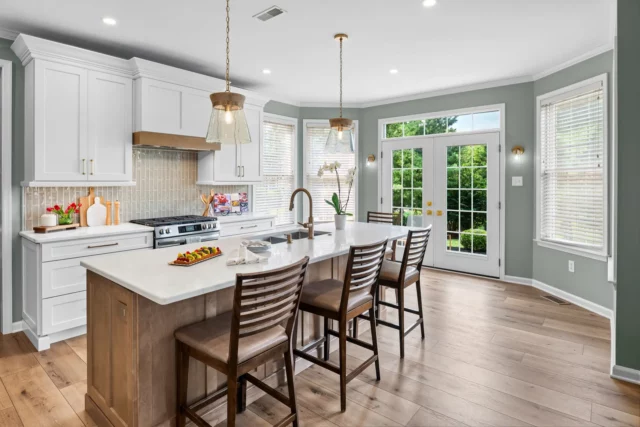The oversized island and new French doors to the backyard in the Lansdale kitchen remodel