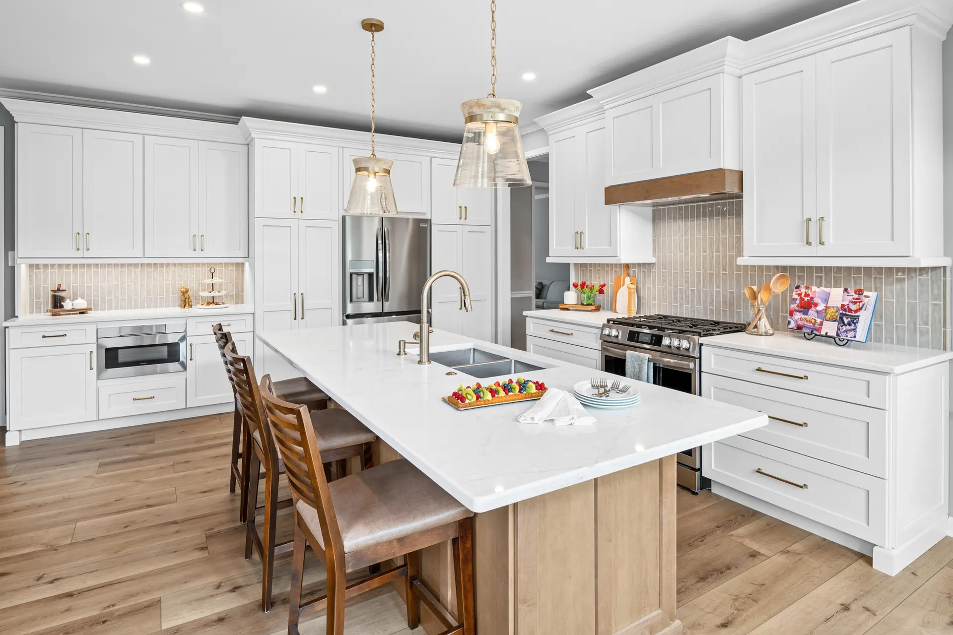 The remodeled Lansdale kitchen with a larger island, white cabinetry, and improved flow to the dining room