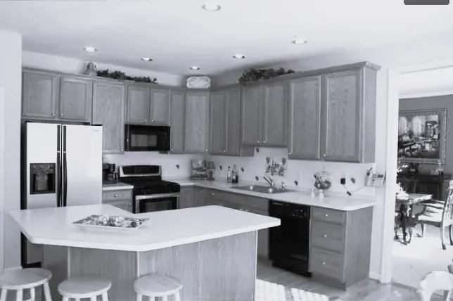 The Lansdale kitchen before its remodel, with dated oak cabinetry and an awkwardly placed island