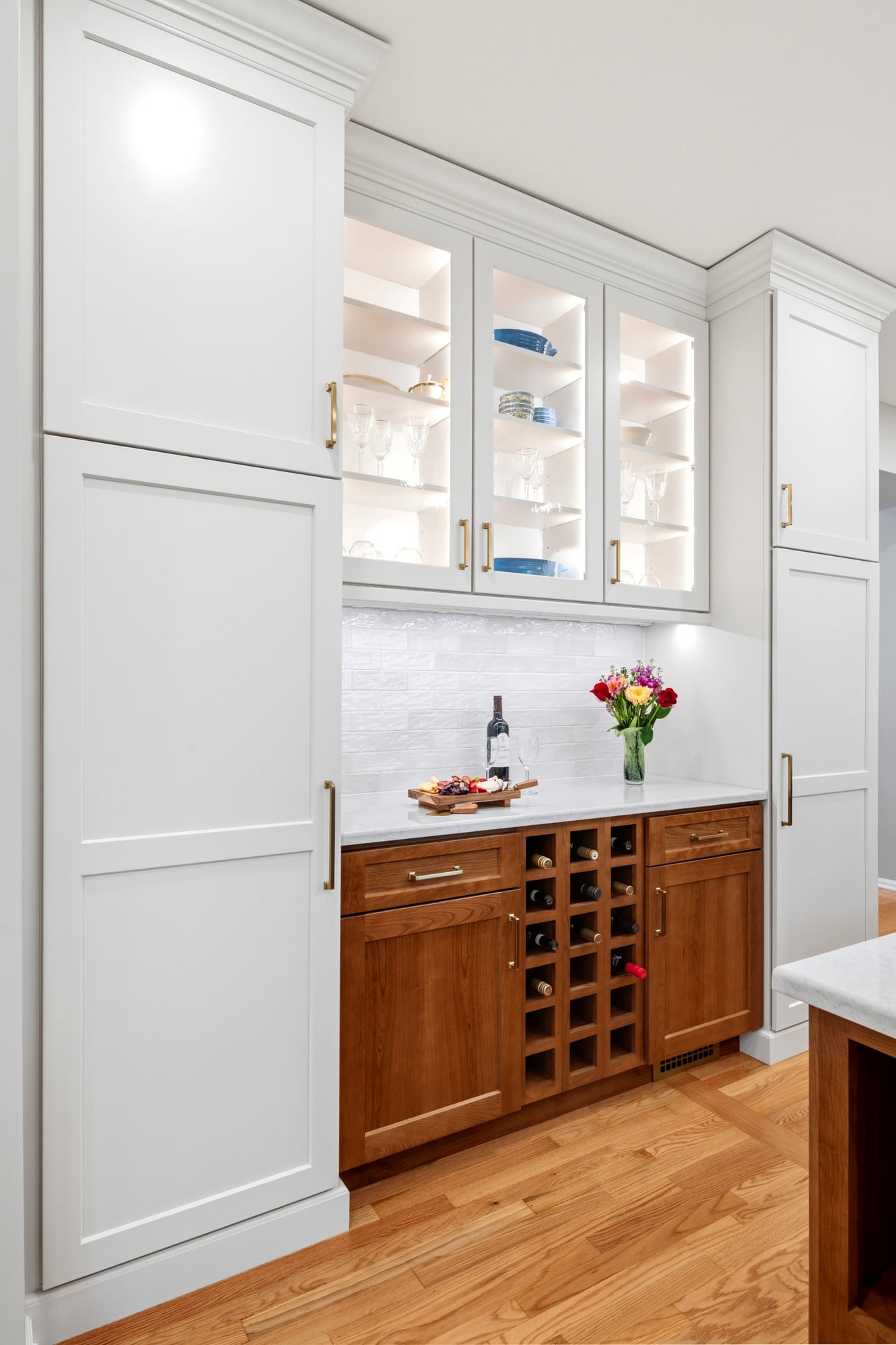 Custom beverage station with coffee storage, wine rack, and glass-front cabinetry