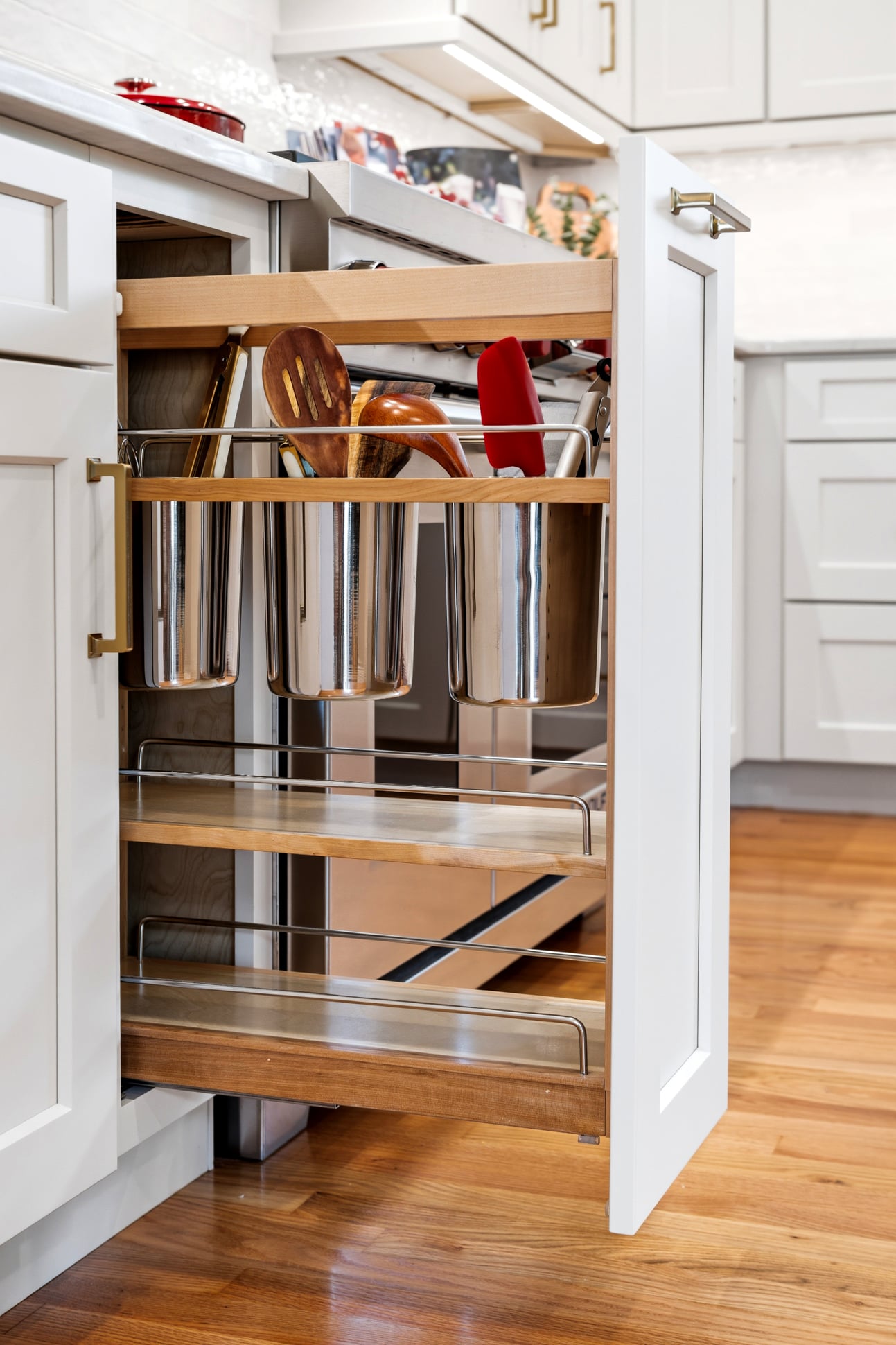 Custom pantry and storage cabinetry maximize organization in this remodeled kitchen