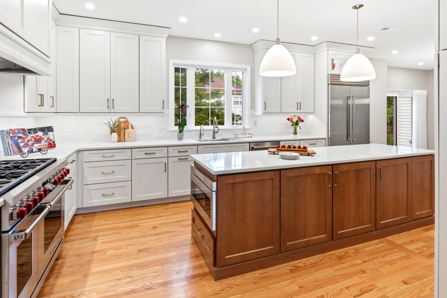 Two-tone kitchen design with white cabinets and a stained wood island