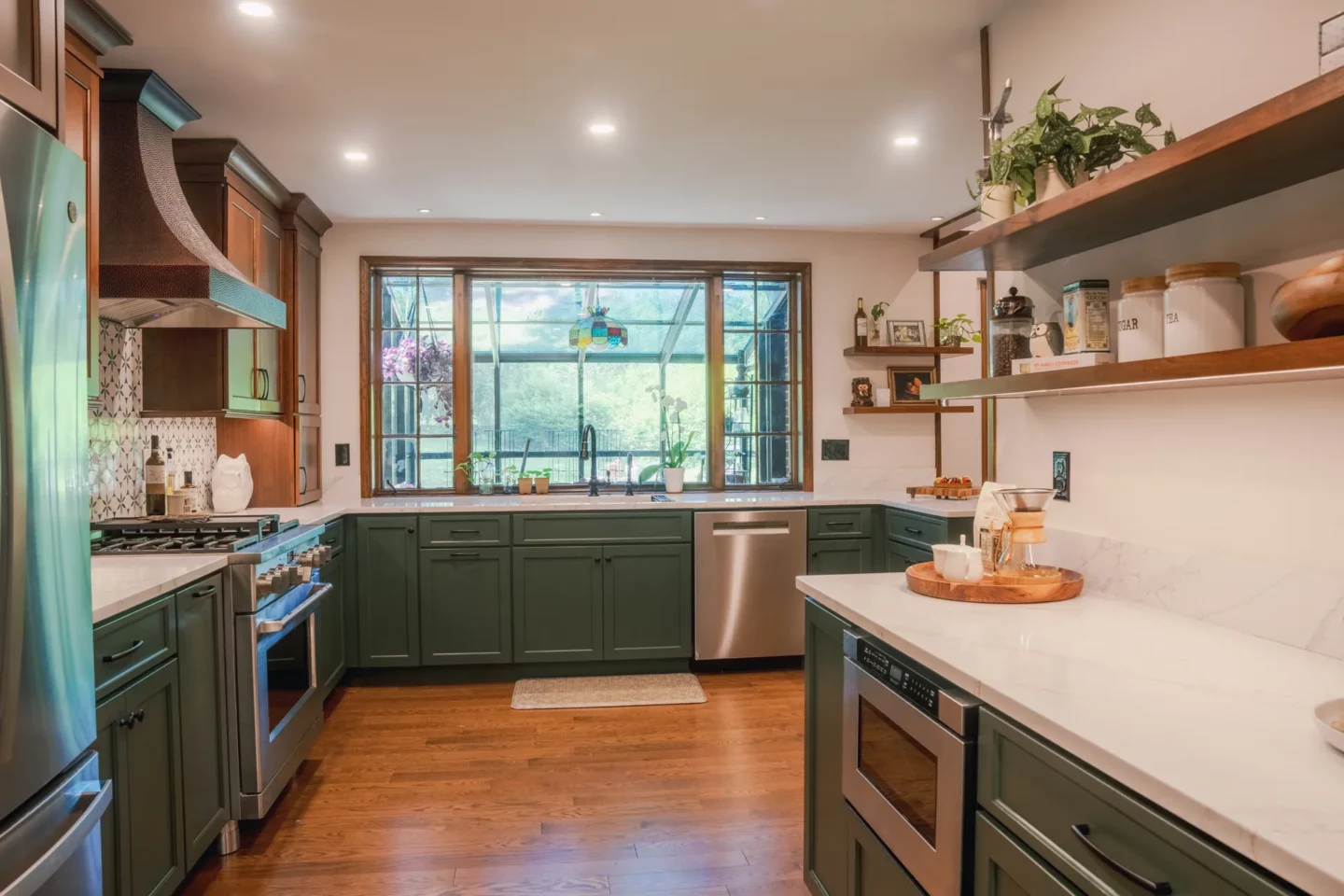 Open-concept kitchen remodel with Olympic Green cabinetry, cherry wood cabinets, and a spacious center island.