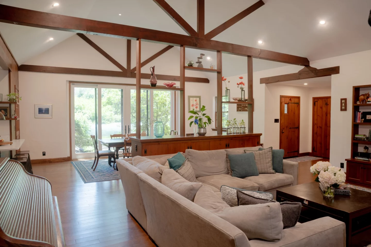 Remodeled family room with vaulted wood ceiling, exposed beams, and improved natural light